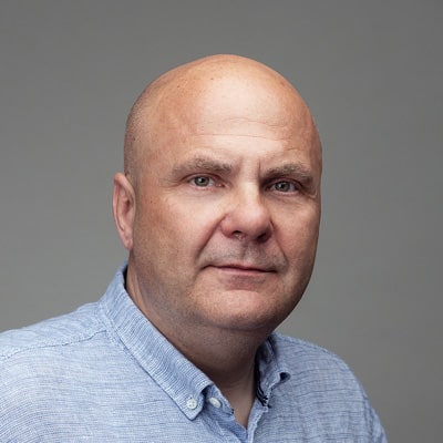 zdjęcie portretowe łysego mężczyzny w średnim wieku, w błękitnej koszuli