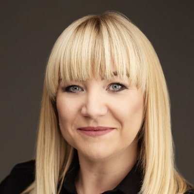 Młoda kobita o blond włosach uśmiecha się