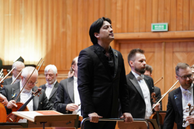 zdjęcie Eugene Tzigana zwróconego do publiczności