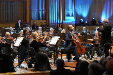 orkiestra symfoniczna na estradzie filharmonii pomorskiej podczas koncertu z wiolonczelistą w młodym wieku