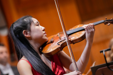 młoda dziewczyna o azjatyckiej urodzie grająca na skrzypcach